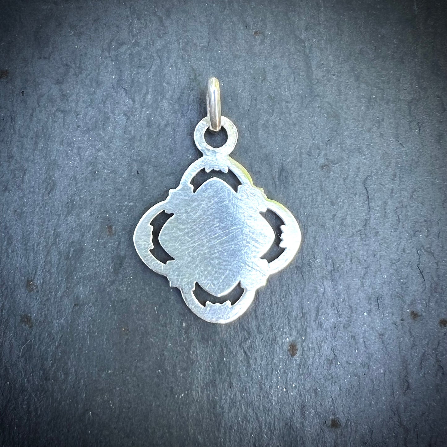 Silver quatrefoil communion medal